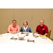 Three individuals sitting at a table for Asset Repositioning.