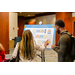 Two individuals looking at a poster board.