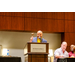 President Anthony Goodson, Jr. standing behind a podium and holding a gavel.