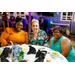 Three woman smiling for the camera with a sound system set up behind them.