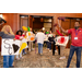 A group of individuals with pom poms and signs welcoming individuals into the event room.