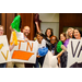 A group photo of individuals holding signs to represent different states while also holding pom poms up in the air.