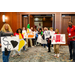 Everyone smiling big while holding various signs for states.