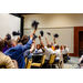 Various individuals excitedly waving black pom poms.