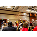 Confetti flying in the air over a crowd waving white pom poms.