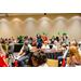 A table on the other side of the room holding and waving green pom poms.