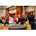 Red pom poms being waved in the air by a large group of people.