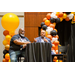 Anthony Goodson, Jr. speaking into a microphone while gesturing to the individual beside him.