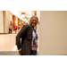 A woman in a black blazer smiling big for the camera.