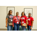 Four people standing against a wall for a photo.