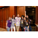 Six individuals taking a group photo. One of them is leaning against the door with her eyes closed and her arm straight up in the air.