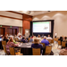 A room full of individuals listening to a presentation.