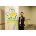 A woman standing next to a banner that says Dublin City Schools Behavioral Health and Wellness.