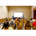 A room full of people looking at a projection screen.