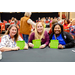 Three women holding up their filled out Bingo cards.