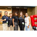 Five women taking a group photo next to the Bingo balloon arch.