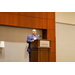 Anthony Goodson, Jr. speaking into a microphone while standing behind a podium.