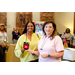 Two women holding up a Macys gift card.