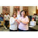 Two women holding up a set of Visa gift cards.